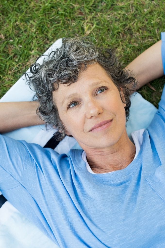 Woman lying outside and thinking